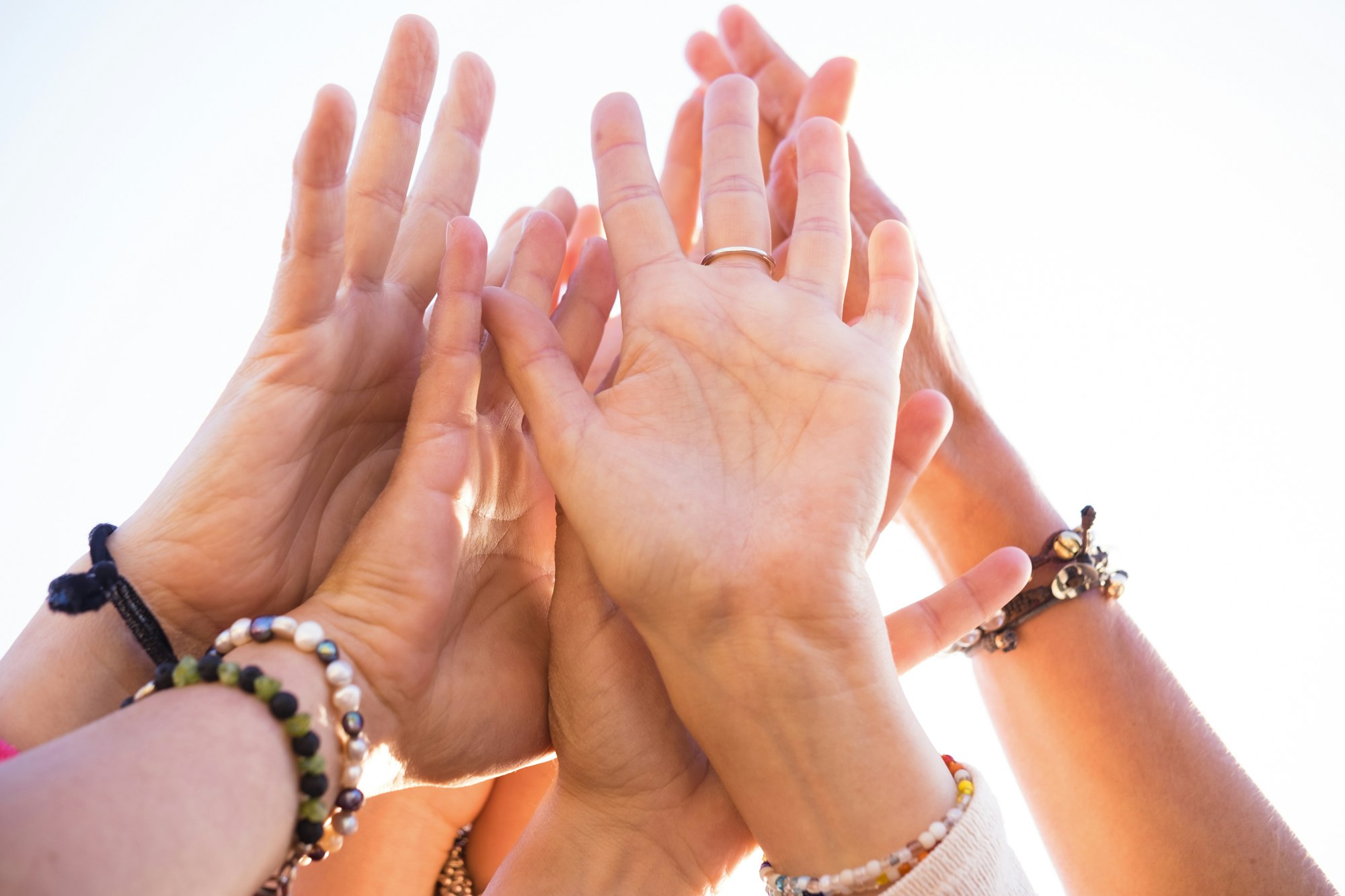 Group of many caucasian hands people together touching - cooperation and team people